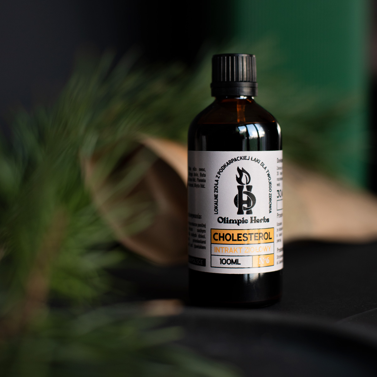 zdjęcie intraktu(buteleczki) ziołowego na cholesterol w zielonej naturalnej scenerii artystycznej