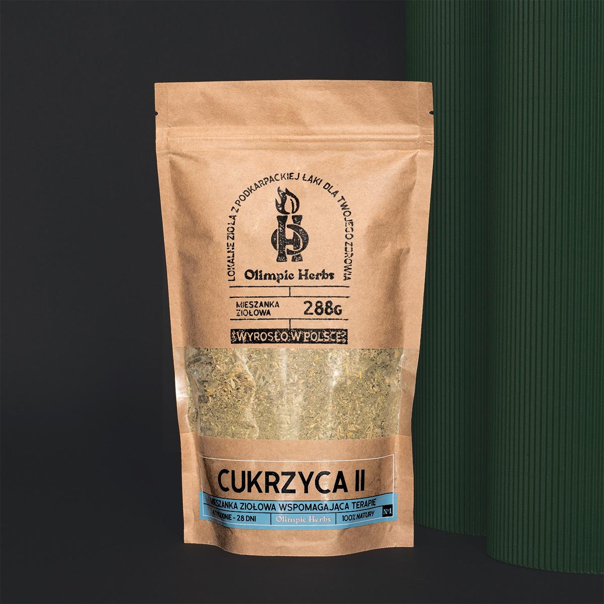 cukrzyca zdjęcie na ciemnym tle produktu przedstawiające brązowe opakowanie z papieru ekologicznego z ziołami wewnątrz (Mieszanka ziołowa) na etykiecie znajdują się niebieskie elementy oznaczające serię ziół na CUKRZYCĘ Olimpic Herbs wspomagające na cukrzyca typu 2
